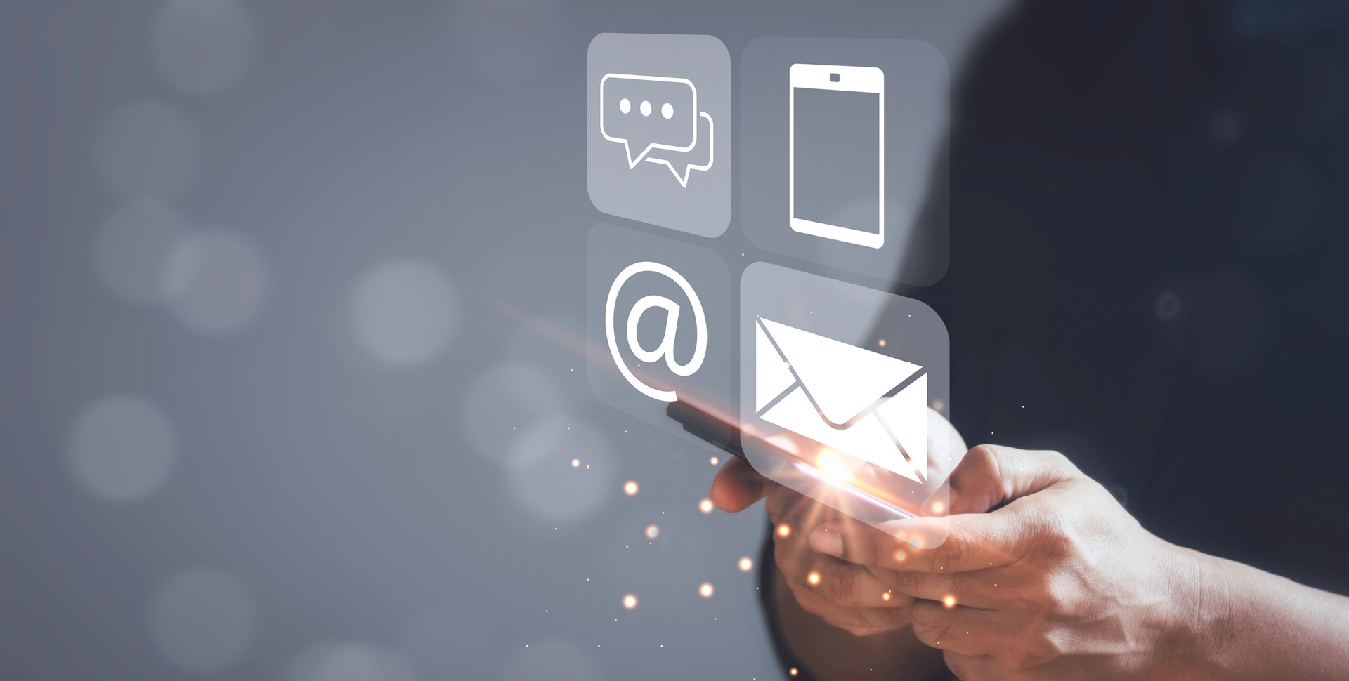 Concept of contact us. Businessman using a smartphone with the  chat box, email, call phone and mail icons.